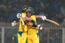 Australia captain Pat Cummins and Mitchell Starc celebrate victory (Aijaz Rahi/AP).