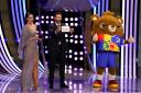Official UEFA Euro 2024 mascot Albart (right) presents the name 'Germany' to former Italy's Gianluigi Buffon during the UEFA Euro 2024 draw at the Elbphilharmonie in Hamburg
