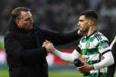 Celtic manager Brendan Rodgers, left, shakes Liel Abada's hand after his side's win over Rangers at Parkhead in December