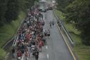 Migrants leave Ulapa, Chiapas state, late Saturday, Oct. 30, 2021. The migrant caravan heading north in southern Mexico has so far been allowed to walk unimpeded, a change from the Mexican government's reaction to other attempted mass migrations. (AP