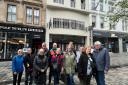 A group of tourists on a Mackintosh-themed walking tour in Glasgow