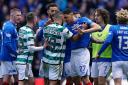 empers flare between Celtic’s Cameron Carter-Vickers and Rangers’ Leon Balogun during the cinch Premiership match at Ibrox Stadium,