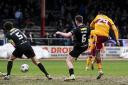 Moses Ebiye caps off a remarkable Motherwell comeback on the rutted Dens Park pitch.