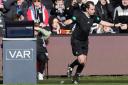 Referee Alan Muir changes his decision following a VAR review