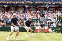 Great Britain's Andy Murray (left) and Jamie Murray (right)  in action during day two of the Davis Cup Quarter Finals between Great Britain and France at the Queen's Club, London. PRESS ASSOCIATION Photo. Picture date: Saturday July 18, 2015. See PA story