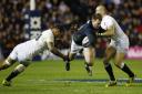 Stuart Hogg is tackled by Courtney Lawes and Mike Brown during Scotland’s defeat at Murrayfield