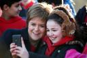 First Minister Nicola Sturgeon has a selfie taken with children from Tolcross Primary School at Edinburgh Castle esplanade as  Visit Scotland launches its new VisitScotland campaign. PRESS ASSOCIATION Photo. Picture date: Wednesday February 10, 2016.