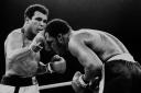FILE - In this Oct. 1, 1975, file photo, Muhammad Ali's throws a right at Joe Frazier in the 13th round in their title bout in Manila, Philippines. Ali, the magnificent heavyweight champion whose fast fists and irrepressible personality transcended sp