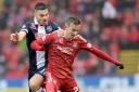 Aberdeen's James Maddison shields the ball from Ross County's Ian McShane during another impressive performance by the young Englishman