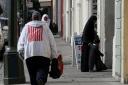 SAN FRANCISCO - NOVEMBER 27:  A man wears an American flag on his jacket as he passes the Alsabeel Masjid Noor Al-Islam mosque November 27, 2009 in San Francisco, California. Eight years after the September 11th terrorist attacks, Muslims in America are o