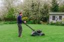 David Hedged-Gower mows the lawn.