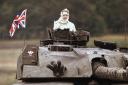 FILE - In this Sept. 17, 1986 file photo, British Prime Minister Margaret Thatcher stands in a British tank during a visit to British forces in Fallingbostel, some 120km (70 miles) south of Hamburg, Germany. Thatcher's former spokesman, Tim Bell, said