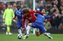 Manchester United's Marouane Fellaini (left) and Chelsea's Cesc Fabregas battle for the ball during the Premier League match at Old Trafford, Manchester. PRESS ASSOCIATION Photo. Picture date: Sunday April 16, 2017. See PA story SOCCER Man Utd. Ph