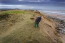 Head greenkeeper at Montrose golf course Gerald Stewart examines the progress of erosion at the third tee. Picture: Paul Reid