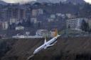 Plane dangles off cliff after skidding off runway in Turkey