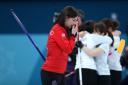 Great Britain's skipper Eve Muirhead is dejected as the Japanese celebrate winning the bronze medal    Photograph: PA