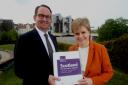 First Minister Nicola Sturgeon receives the Growth Commission report from commission chair Andrew Wilson.