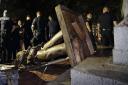 Police stand guard after the Confederate statue known as Silent Sam was toppled by protesters on campus at the University of North Carolina in Chapel Hill
