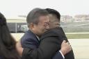In this image made from video provided by Korea Broadcasting System (KBS), South Korean President Moon Jae-in, left, hugs North Korean leader Kim Jong Un upon arrival in Pyongyang, North Korea, Tuesday, Sept. 18, 2018. Moon landed in Pyongyang for his thi