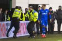 Rangers captain James Tavernier confronts a fan who ran on the pitch