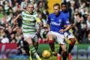 
Celtic's Scott Brown (L) competes with Rangers' Scott Arfield.