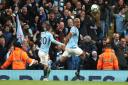 Manchester City's Vincent Kompany (right) celebrates scoring against Leicester this week to stay in pole position for the title