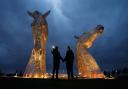 Roger Deacon and Pauline Stewart from Falkirk pictured at the Kelpies sculptures near Falkirk. The Kelpies, along with other prominent landmarks turned yellow this evening to remember the victims of the covid pandemic. Photograph by Colin Mearns.