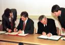 The then Prime Minister Tony Blair and the Irish Taoiseach Bertie Ahern sign the Good Friday Agreement in April 1998. The author is on the left, showing Mr Blair where to sign.