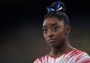 Simone Biles contemplates her score at the Tokyo Olympics