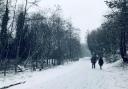 People walking in a snowy wintery scene. Credit: PA