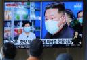 People watch a TV screen showing a news program reporting with an image of North Korean leader Kim Jong-un, at a train station in Seoul, South Korea, Monday, May 16, 2022. Kim blasted officials over slow medicine deliveries and ordered his military to