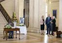 Sinn Fein Vice President Michelle O'Neill, UUP leader Doug Beattie, Assembly Speaker Alex Maskey and the DUP's Joanne Bunting chat as the Alliance's Andrew Muir signs a book of condolence in Stormont. Photo PA.