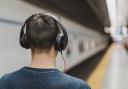 A man listening to music on his headphones. Credit: Canva