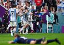 Lionel Messi celebrates with Luka Modric in the foreground