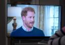 A viewer at home in Edinburgh watching the Duke of Sussex being interviewed by ITV's Tom Bradby during Harry: The Interview, two days before his controversial autobiography Spare is published.