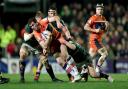 Emiliano Boffelli is brought down by Leicester Tigers players
