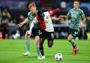 Celtic defender Liam Scales, left, tries to tackle Feyenoord forward Yankuba Minteh in a Champions League match in Rotterdam on Tuesday night