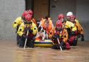 Members of the emergency sevices helping a man to safety  when Storm Babet hit Brechin in October.