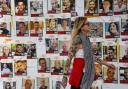 A woman in Tel Aviv walks past pictures of hostages captured by Hamas on April 7