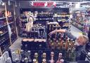 An employee arranges bottles of sparkling wine at a supermarket in Moscow