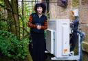 Dr Jane May Morrison pictured with her heat pump at her ground floor tenement flat in the Southside of Glasgow