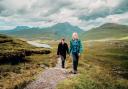 Woman and her adult son on the Knockan Crag trail above the Geopark between Ullapool and Elphin in the Assynt region of the Scottish Highlands.