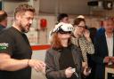 Vicky Allan tries out VR training equipment at Mitsubishi heat pump training centre