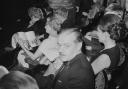 Scottish novelist Alistair MacLean (1922 - 1987) sitting among the crowd at a theatre, UK, 2nd April 1969
