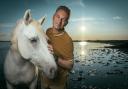 Chris Packham and horses in the Camargue, France. He will visit the area later in the series