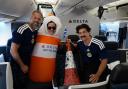 Andrew Dobbie, a member of the Delta cabin crew, the cone and Danny Campbell, a traffic cone which has been flown from Scotland to Boston as a symbol of friendship