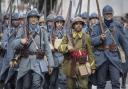 Men dressed in WWI uniforms march during a parade, part of a reconstruction of the WWI battle of Verdun, Saturday, Aug. 25, 2018, in Verdun, eastern France.  Hundreds of volunteers from 18 countries gathered in the French town Verdun as part of a string