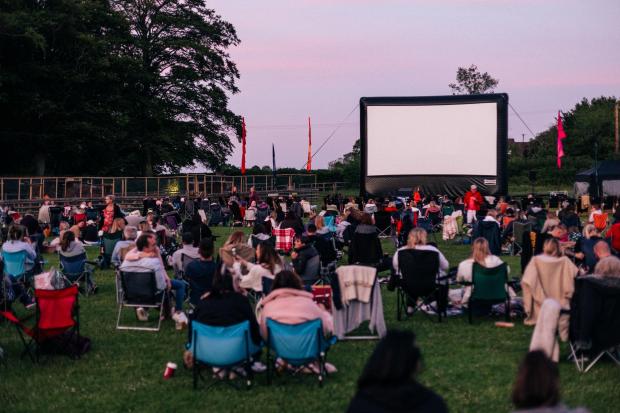 HeraldScotland: People at an outdoor cinema event. Credit: Adventure Cinema