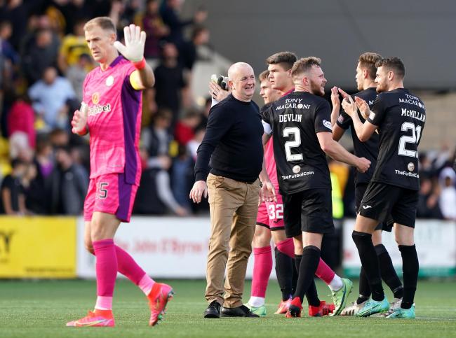 Joe Hart holds up a hand of apology to Celtic supporters after the loss to Livingston.