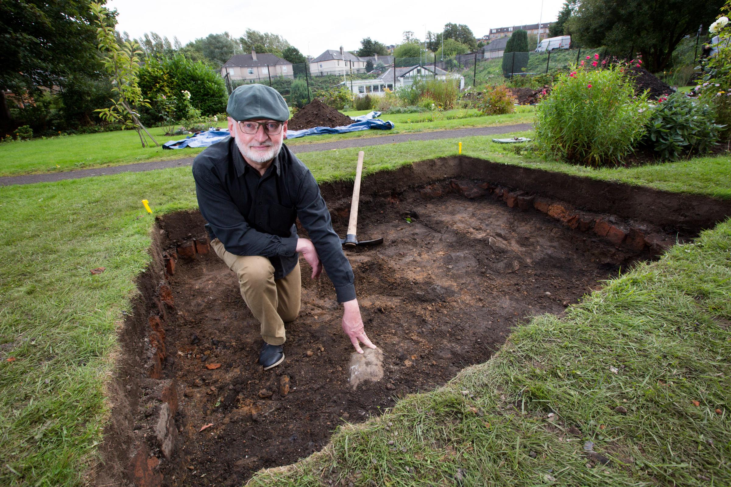 Ged OBrien at the archaeological dig site and his hand is on what is believed to be the foundations of the original pavilion.